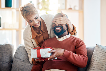 Image showing Black couple, surprise gift and Christmas present in festive summer season from wife with love, happiness and holiday celebration. Black woman, happy man and smile the living room home sofa together