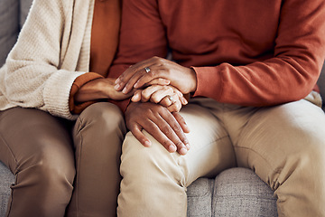 Image showing Black couple, holding hands on sofa or comfort support, care and love bonding together in home living room. Black man, black woman sitting couch and embrace with kindness, trust and help with problem