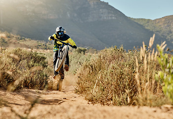 Image showing Mountain bike man, extreme sports and jump outdoor on dirt track, cycling competition or adventure. Nature bicycle ride, mountain hill bush and speed action in race, safety helmet and sportswear