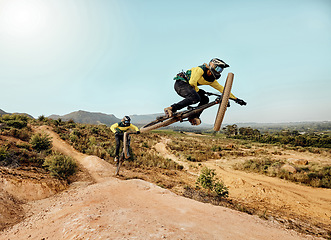 Image showing Mountain bike, extreme sports jump and outdoor dirt track for friends on cycling adventure in nature. Bicycle team ride, mountain hill rocks and action race with speed, stunt and danger trick in air