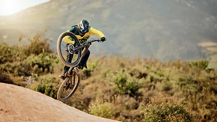 Image showing Bicycle, biker and jump in air for competition, mountain biking and extreme sport with helmet, outdoor and in nature. Athlete, bike and cycling for fun, freedom and health for adventure and wellness