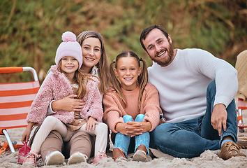 Image showing Beach, winter and portrait of kids with parents sit on sand on holiday picnic. Mom, dad and children relax at ocean in Australia. Freedom, fun and vacation, happy man and woman with girl kids at sea.