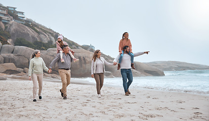 Image showing Big family, beach and walking for bonding with generations in winter by the sea water. Mother, father and grandparents together being loving and caring while on holiday or vacation for relaxation