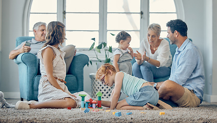 Image showing Big family, bonding and children playing in living room, relax and cheerful in their home together. Happy grandparents, parents smile and enjoy fun, watching kids play on floor while resting on couch