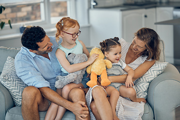 Image showing Family, happiness and love on home sofa with children holding stuffed animal toys while bonding with mom and dad parents. Woman, man and girl kids together for care, development and quality time