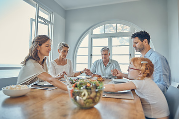 Image showing Lunch, praying and family together at dining room table in home. Grandparents, child and parent teaching grace or spiritual religion prayer respect to kid before dinner in religious retirement house