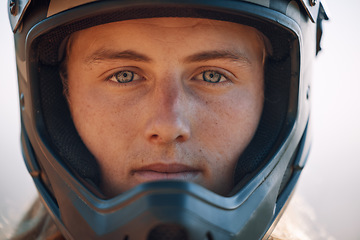 Image showing Face, helmet and extreme sports with a man biker outdoor alone for adventure or adrenaline. Portrait, safety and motocross with a confident male rider outside alone for fun or recreation closeup