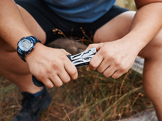 Image showing Man, hands and multi purpose blade on sustainability environment camping, forest woods or hiking mountains. Zoom, swiss army knife and tools in survival gear or metal equipment for nature earth hiker