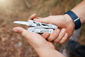 Image showing Man, multi purpose knife and camping in nature, forest and survival gear for adventure in mountains, woods and park. Guy hands, pocket tools and practical swiss metal weapon object for outdoor hiking