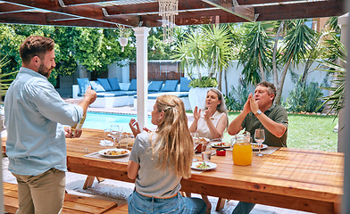 Image showing Champagne, celebration and family with applause at lunch party with food, love and relax in garden of house. Wine, happy and man with alcohol at barbecue with woman and senior parents in a backyard