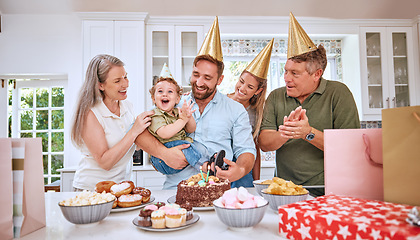 Image showing Baby, birthday party and family celebration at a kid event with mother, father and friends. Young child and parents celebrate event with food clapping for a happy boy in a family home kitchen