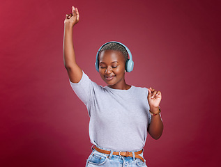 Image showing Studio, dance and black woman streaming music and dancing with freedom and happiness to relax. Smile, headphones and happy African girl enjoys listening to a gospel worship song or audio on radio