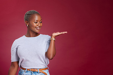 Image showing Studio woman, advertising mockup and red background, marketing space and blank wall design for presentation, product placement and promo commercial. Happy young black model, mock up and offer advice