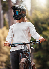 Image showing Biker, mountain bike and competition outdoor for extreme sports, helmet and have fun in summer, sunlight and in nature. Young man, athlete and bicycle with head gear for safety, protection and glare