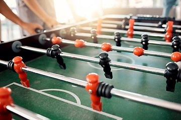 Image showing People hands, foosball table and competition in arcade with retro games, soccer action board and plastic toys for team play. Closeup of tabletop soccer challenge, football fun and party entertainment