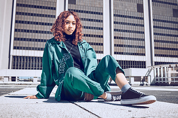 Image showing Fashion, city and gen z portrait of girl resting on outdoor floor of urban building in New York. Youth, edgy and young woman in town with retro and sporty 90s clothes style relaxed on ground.