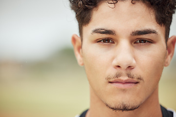 Image showing Man, face and serious facial expression of a person from Madrid with mock up in nature. Portrait of a young, student and male head feeling calm and relax outdoor with focus and mockup space