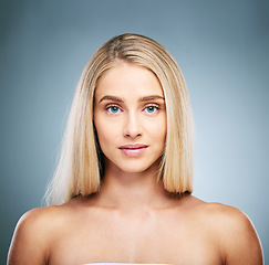Image showing Portrait, face and beauty with a model woman in studio on a gray background to promote natural skincare. Wellness, hair and luxury with an attractive young female inside to endorse cosmetics