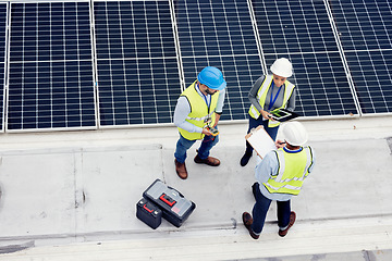 Image showing Engineering, solar panel and top view of team in discussion for inspection or installation. Sustainable, clean and solar energy from photovoltaic cells with industry people in collaboration on a site