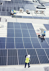 Image showing Solar panel, construction and industrial employees on roof for solar energy, engineering and sustainable lifestyle. Building, sustainability and teamwork for clean electricity and photovoltaic power