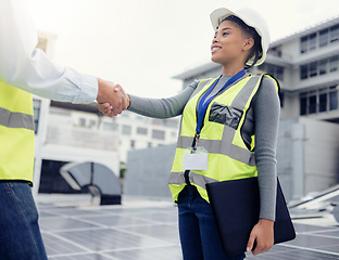 Image showing Engineering team handshake, black woman at solar panel construction site or architecture project partnership. Working on building roof, industrial collaboration or contractor welcome employee