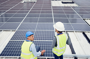 Image showing Solar energy, construction and employees building solar panels in collaboration for sustainability, maintenance and engineering. Teamwork, planning and construction workers talking about clean energy