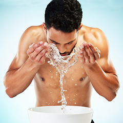 Image showing Water splash, studio and man cleaning face in a daily grooming morning routine for healthy skincare hygiene. Beauty, wellness and young male model washing or grooming in self care cleansing treatment