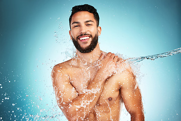 Image showing Man, skincare and water splash shower in studio for wellness, health and grooming in blue background mockup. Cleaning, skin and beauty with model washing hygiene and relax, pamper or body in bathroom