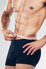 Image showing Fitness, lose weight and measuring tape of man to check waist size, progress and diet or workout, exercise and training results. Body motivation of healthy bodybuilder goals for health and wellness