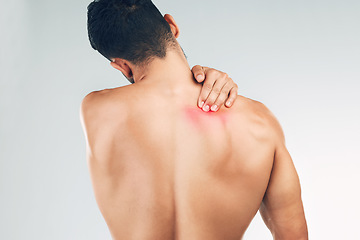 Image showing Back pain, injury and man with medical problem, tension and stress against grey mockup studio background. Back of a person with a body symptom, inflammation and muscle pain with mock up space