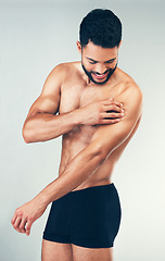 Image showing Fitness, body of man and arm injury after intense workout, training or exercise on studio background. Accident, healthcare and topless male model suffering from joint inflammation or muscle pain.