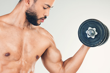 Image showing Bodybuilder, strong and man with dumbbell in studio doing weight lifting, exercise and workout. Fitness, training and male for gym motivation lifting weight for strength in arm, bicep and body muscle