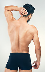 Image showing Back, body and underwear with a man model in studio on a gray background for health, wellness or care. Fitness, exercise and strong with a muscular male standing inside to promote healthy lifestyle