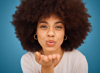 Image showing Woman model, fashion and blow kiss for beauty, makeup and empowerment in skincare and afro hair. Headshot portrait of creative young brazilian girl or happy black person in blue studio background