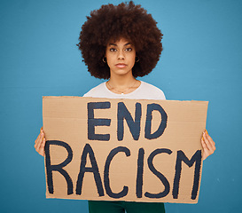 Image showing Portrait of a black woman with a stop racism banner and peacefully protesting for human rights in studio. Young afro girl with a cardboard poster fighting for race, social justice or racial equality