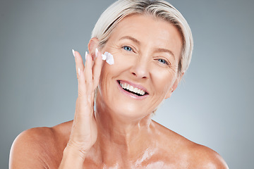 Image showing Beauty, senior and portrait of woman with cream on face for skincare, health and cosmetic antiaging. Happy, mature and natural cosmetics for skin model advertising with gray studio mockup.