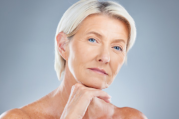 Image showing Face, beauty and skincare with a senior woman in studio on a gray background for antiaging treatment. Cosmetics, luxury and natural with a mature female posing to promote a body care product
