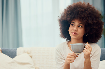 Image showing Coffee, thinking and mockup with a black woman in the living room of her home to relax alone. Idea, tea and weekend with an attractive young female sitting on a sofa in her house on the weekend