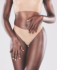 Image showing Body, hands and beauty with a model black woman in studio on a gray background wearing underwear. Health, fitness and lingerie with a female posing for diet, weightloss or a healthy lifestyle