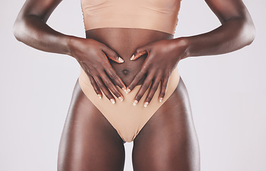 Image showing Healthy black woman, heart hands and stomach diet, weightloss wellness and gut health, body contouring and slimming on studio background. Fitness model abdomen, love and digestion, skincare and belly