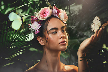 Image showing Beauty, flowers and butterfly with a model woman in studio on a forest or amazon background for wellness. Nature, spring and luxury with an attractive young female posing to promote natural care