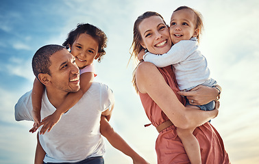 Image showing Happy family, blue sky and ocean, piggy back and hug for couple with kids on summer holiday at beach. Love, family and fun, man and woman smile with children sea for vacation time together at sunset.