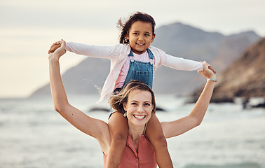 Image showing Family, beach and vacation with mother and child outdoor for travel, adventure and bonding in nature for love, support and care. Portrait of woman carrying girl on shoulders by sea after adoption