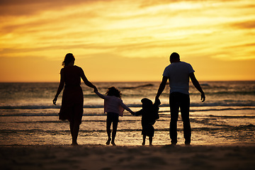 Image showing Family, holding hands and silhouette at the beach at sunset, adventure and love with parents and children outdoor. Mother, father and kids together, trust and freedom by the ocean, nature and care.