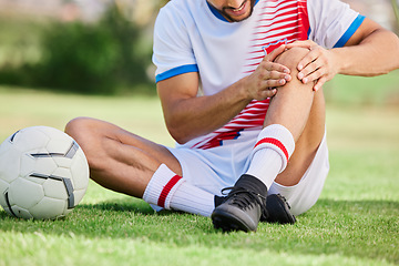 Image showing Fitness, knee pain or soccer player with injury for football exercise, sports training or training on grass soccer field. Sport, soccer athlete or man on ground for health or medical workout accident