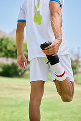 Image showing Soccer, sports and athlete stretching his leg before a match, training or practice on an outdoor field. Football, workout and man doing a warm up exercise for game or workout on a pitch at a stadium.