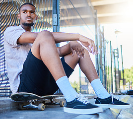 Image showing Cool black man, skateboard and freedom at urban skate park, city and relaxing summer for training, outdoor action and sports hobby in USA. Young skater guy, youth culture and hipster street lifestyle