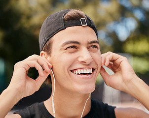 Image showing Music, fitness and exercise with a sports man listening to audio during his outdoor workout or training. Running, health and motivation with a young male athlete outside for cardio or endurance