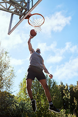 Image showing Basketball, black man and shooting, athlete and fitness, playing sports on outdoor basketball court and jumping. Active, exercise and sport with muscle, strong and training with workout in nature.