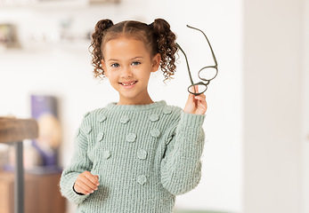 Image showing Glasses, optometry and girl with decision for vision, test for eyes and healthcare at a store, clinic or shop. Advertising, smile and child with eyeglasses from an optometrist and happy with choice